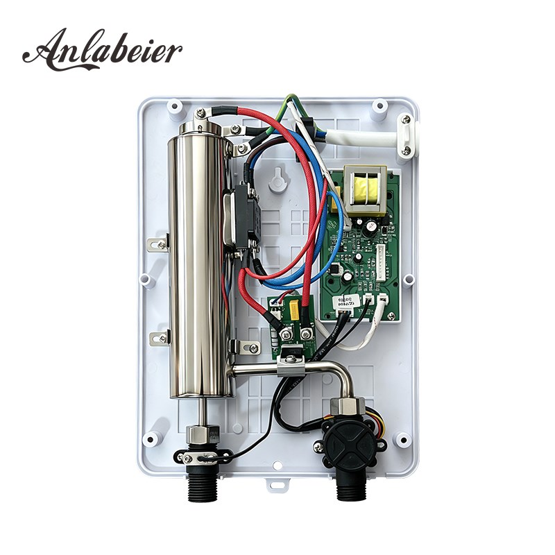 Inside an instant electric water heater: stainless steel heating chamber and water connections
